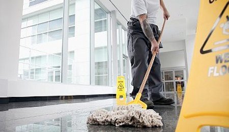 Office cleaner cleaning floor --- Image by © Drew Myers/Corbis